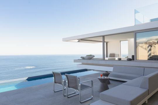 Modern, luxury home showcase exterior patio with lap pool and ocean view
