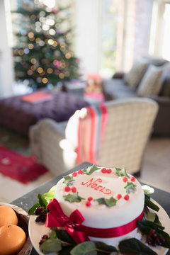 Decorated noel Christmas cake on sideboard in living room