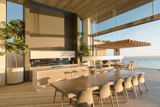 Sunny modern, luxury home showcase interior dining table with ocean view