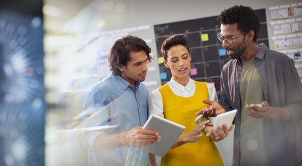 Creative business people planning, using digital tablets in office