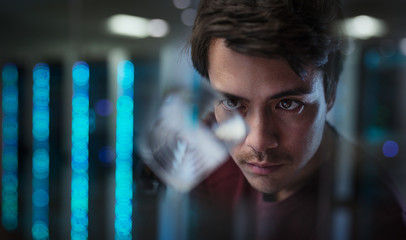 Male innovator examining prototype