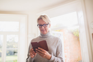Mature woman reading diary