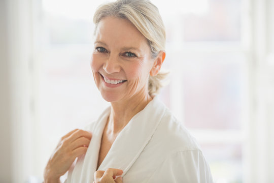 Portrait smiling, confident mature woman in bathrobe