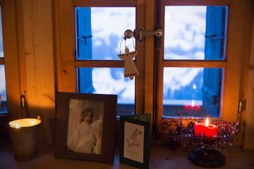 Christmas decorations and candle on  windowsill