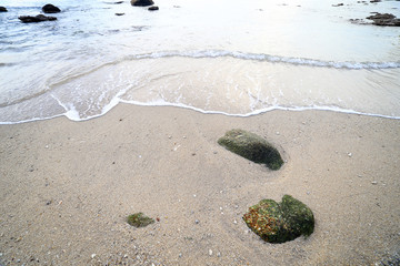 Rock and wave on the Ao Sen beach Phuket Thailand