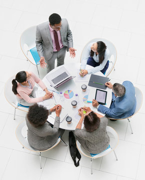 High angle view businessman leading meeting at round table