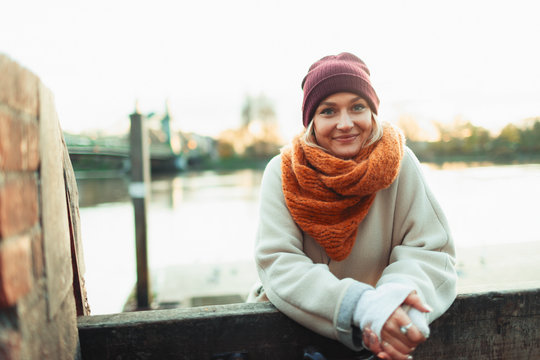 Portrait confident young woman in stocking cap and scarf