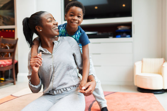 Portrait playful, happy mother and son in living room
