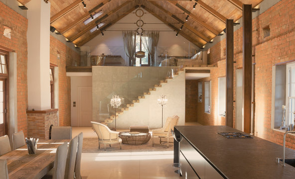 Home showcase interior with vaulted ceiling and loft