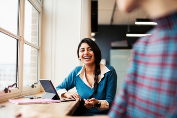 Portrait happy, laughing businesswoman in office