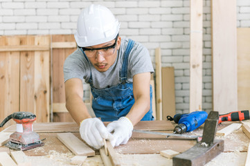 Carpenter is using a tool for woodworking. Man with carpenters tools construction concept.