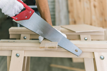 Carpenter is using a tool for woodworking. Man with carpenters tools construction concept.