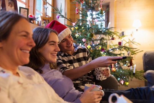 Family relaxing, watching TV in Christmas living room
