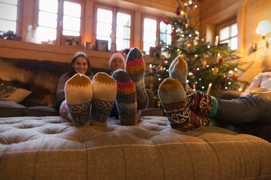 Family with colorful socks relaxing in Christmas living room