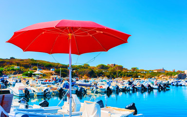 Old Sardinian Port and marina with ships at Mediterranean Sea in city of Villasimius in South Sardinia Island Italy in summer. Cityscape with Yachts and boats