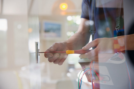 Electrician changing light switch