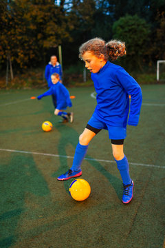 Girl soccer player practicing on field