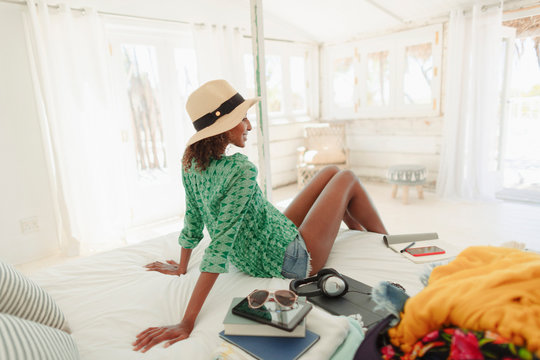 Woman relaxing on beach hut bed