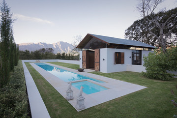 Idyllic, luxury lap pool and pool house with mountains in the background