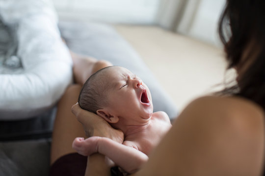 Mother Holding Crying Newborn Baby Son