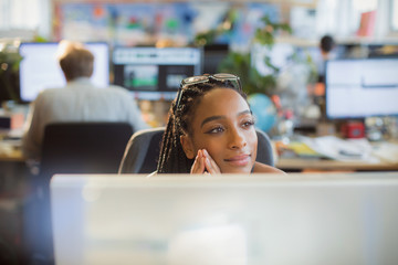 Thoughtful, serene businesswoman at computer in office