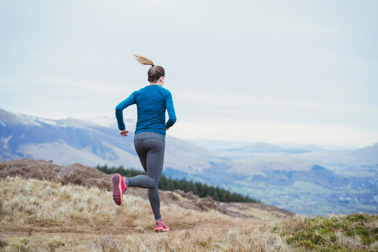 Woman jogging on mountain trail