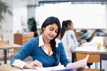 Businesswoman reviewing paperwork in office