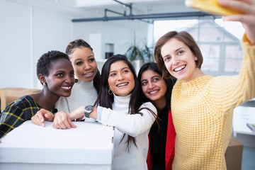 Happy businesswomen taking selfie