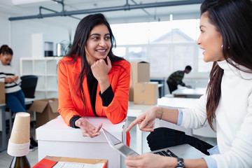 Businesswomen talking in new office