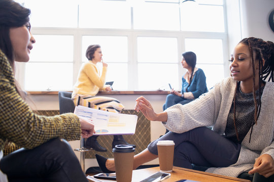 Businesswomen discussing paperwork in office