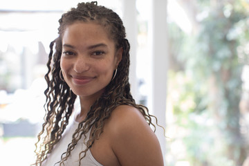 Portrait confident beautiful young woman with curly hair
