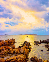 Landscape with Romantic sunset at Capriccioli Beach in of the Mediterranean sea on Sardinia island in Italy. Sky with clouds. Porto Cervo and Olbia province. Mixed media.