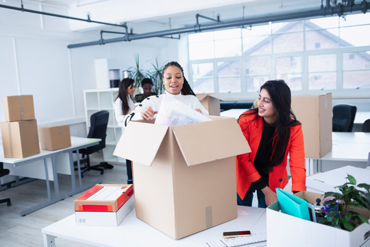 Businesswomen unpacking, moving into new office