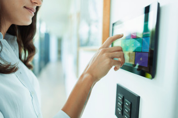 Close up woman at home automation touch screen panel