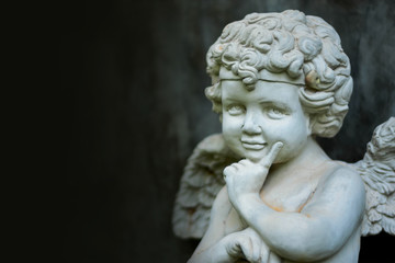 Fototapeta na wymiar Stucco doll, Cupid, the god of conveying love in Western beliefs 