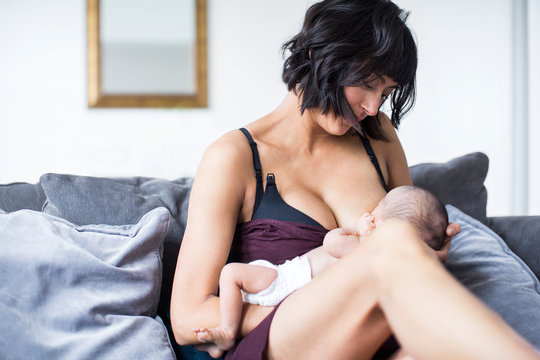 Mother breastfeeding newborn baby son