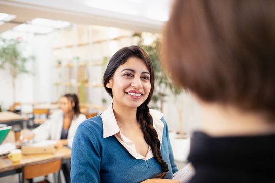 Smiling businesswomen talking in office