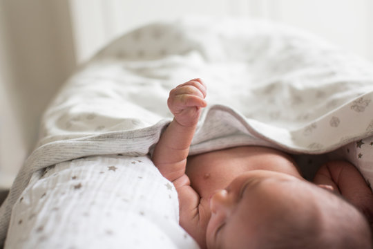 Close Up Newborn Baby Boy Laying In Bassinet