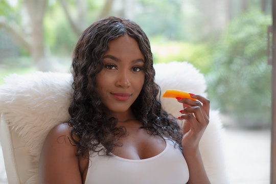 Portrait Confident Young Woman Eating Fruit