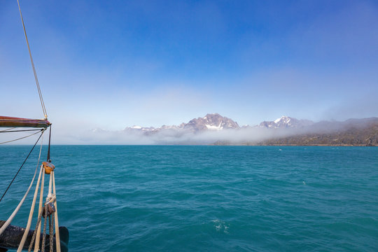 Scenic view fog breaking over scenic mountains Atlantic Ocean Greenland