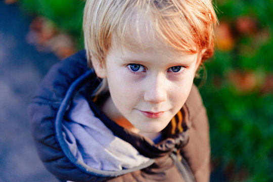 Portrait Confident Boy With Blond Hair And Blue Eyes