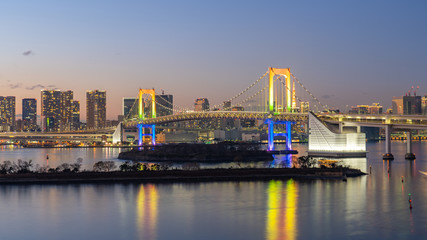 Fototapeta na wymiar Tokyo city skyline at night with view of Rainbow bridge in Japan