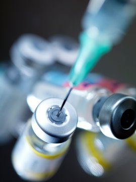 Needle inserted into a vaccine vial