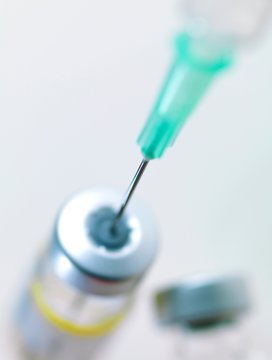 Needle inserted into a vaccine vial
