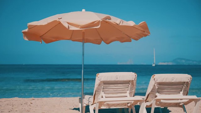 Sunbeds and umbrella prepared for tourists on Balearic island Formantera beach