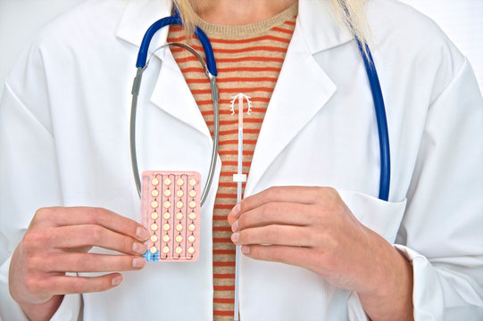 Doctor holding intra uterine device and p
