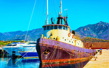 Old Sardinian Port and marina with ships at Mediterranean Sea in city of Villasimius in South Sardinia Island Italy in summer. Cityscape with Yachts and boats