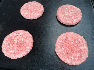 Rare Hamburgers on a black plate