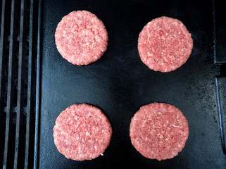 Rare Hamburgers on a black plate