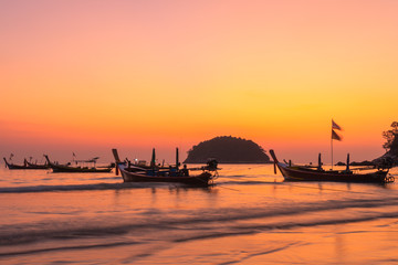 Naklejka na ściany i meble fishing boats in sunset at Kata beach Phuket Thailand